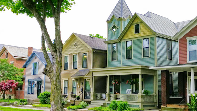 Four colorful historic homes on a residential street